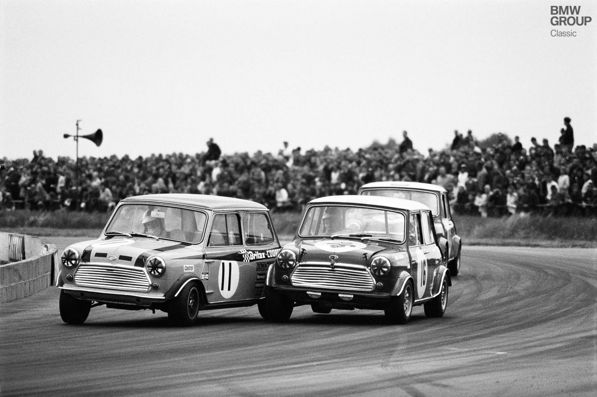 Steve Neal on a Morris Mini-Cooper S, entered by Britax-Cooper-Downton, in front of John Rhodes