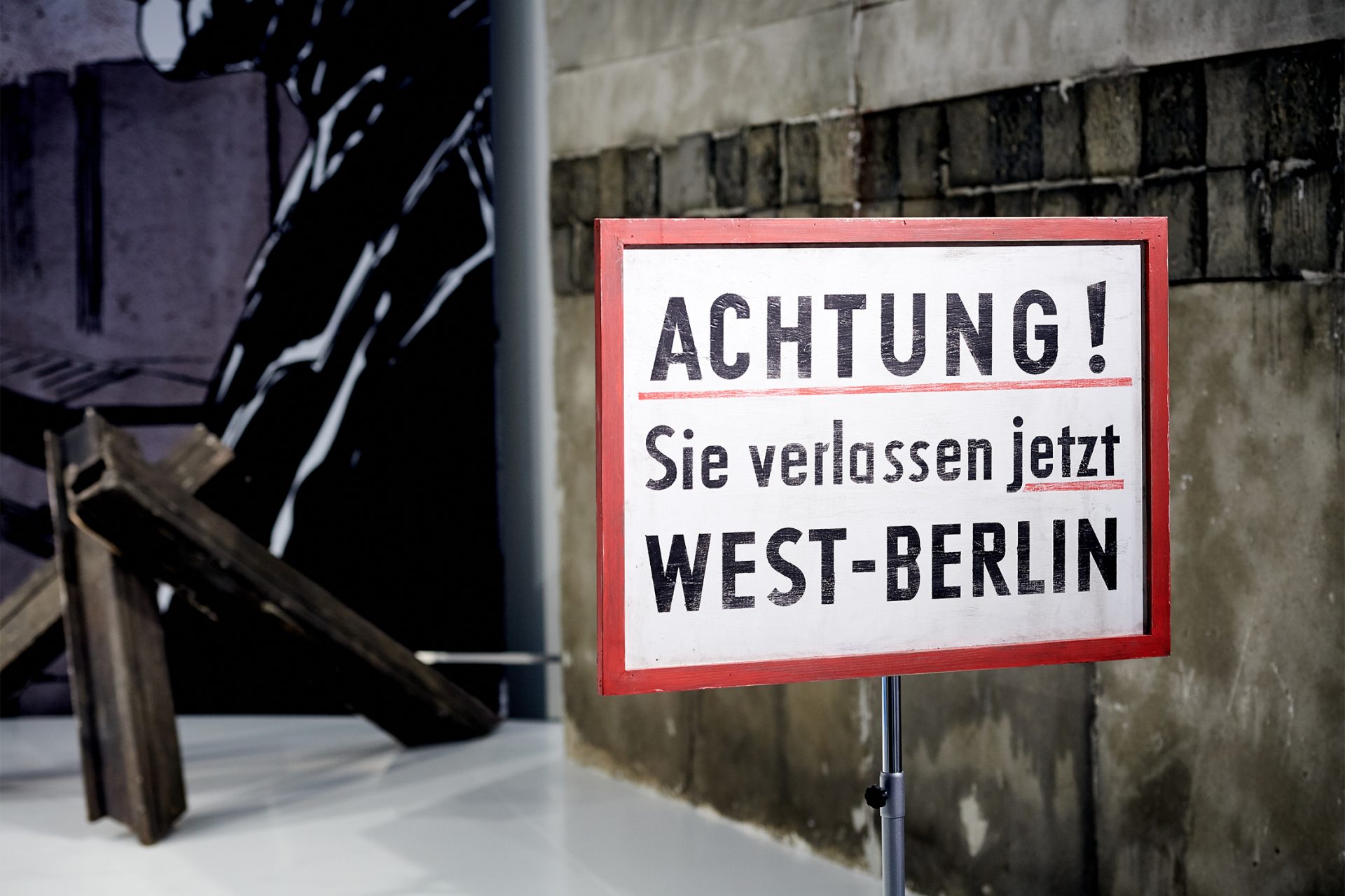 A warning sign with you are now leaving west Berlin on it